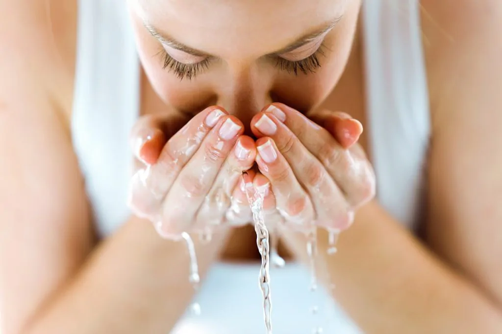 Kobieta myjąca twarz